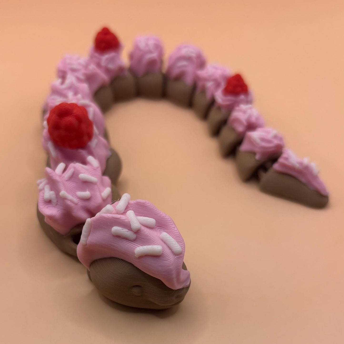 Slinkie Slice – The Cake-Themed Articulated Snake with Sweet Moves