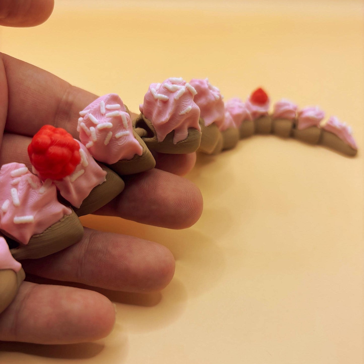 Slinkie Slice – The Cake-Themed Articulated Snake with Sweet Moves