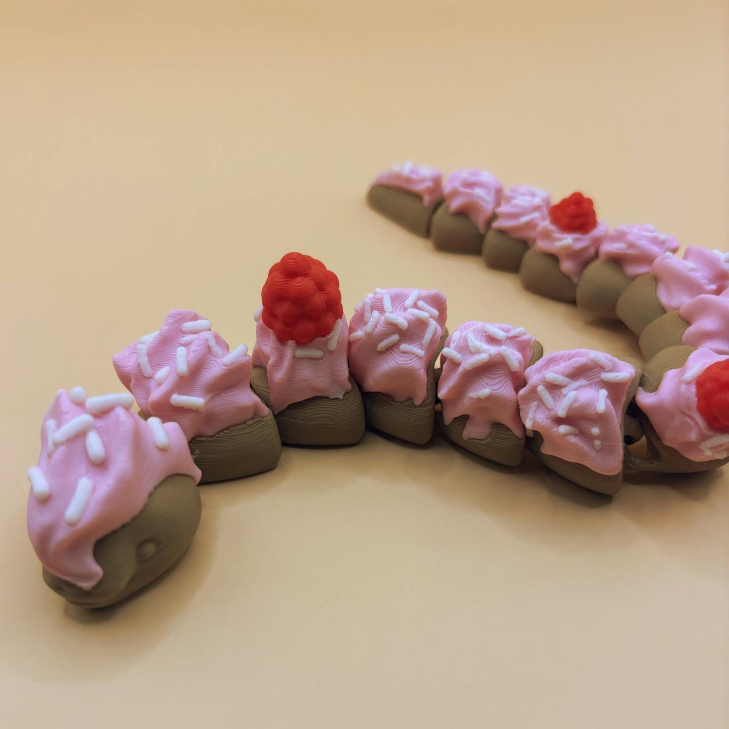 Slinkie Slice – The Cake-Themed Articulated Snake with Sweet Moves