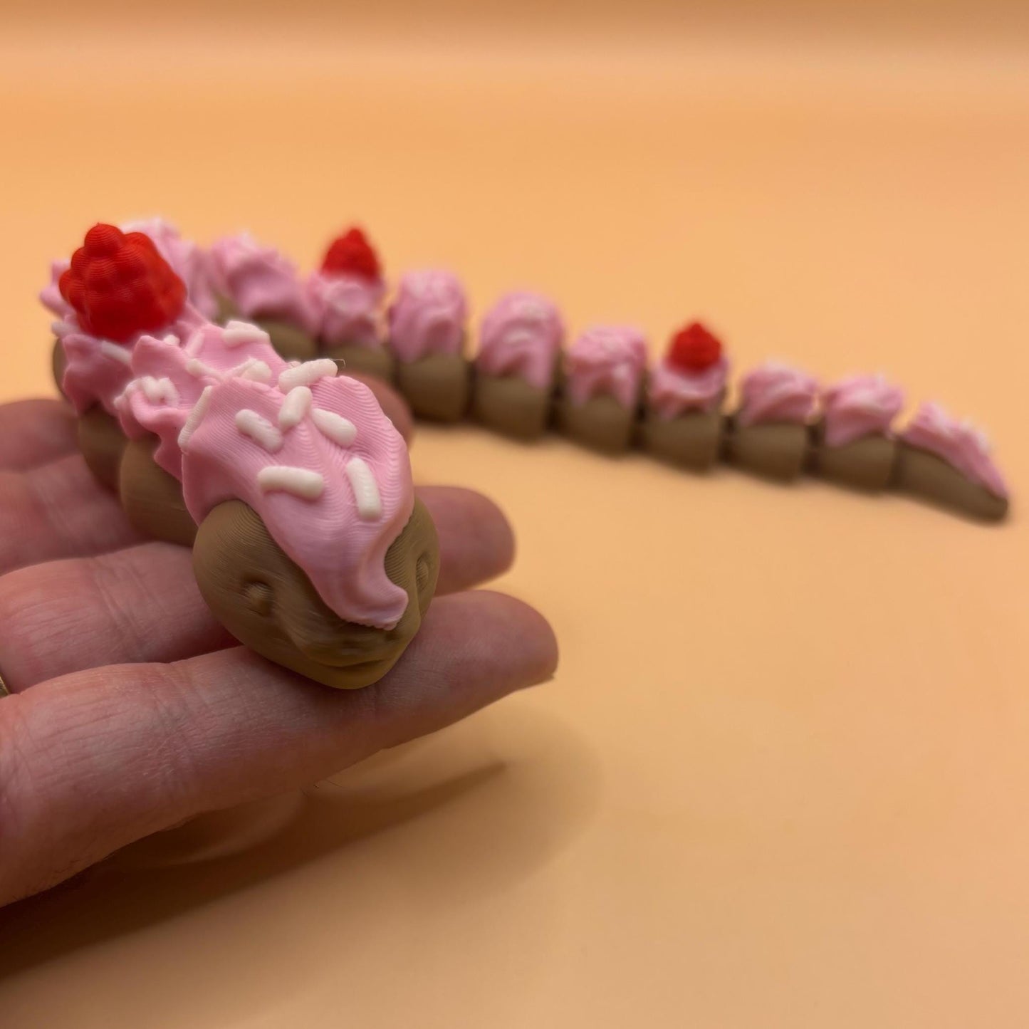 Slinkie Slice – The Cake-Themed Articulated Snake with Sweet Moves
